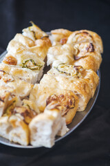 Freshly baked focaccia bread slices with golden crust and airy texture on a tray