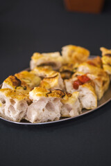 Freshly baked focaccia bread slices with golden crust and airy texture on a tray