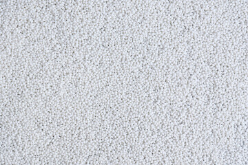 Close-up abstract background of white granules. Design template.
