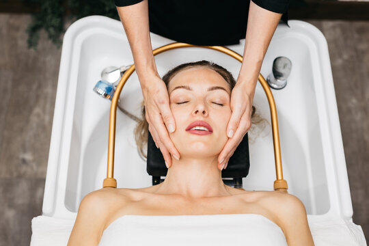 Head massage treatment performed by skilled hands of a masseur in a serene Japanese spa environment, promoting relaxation and rejuvenation for the client experiencing tranquility
