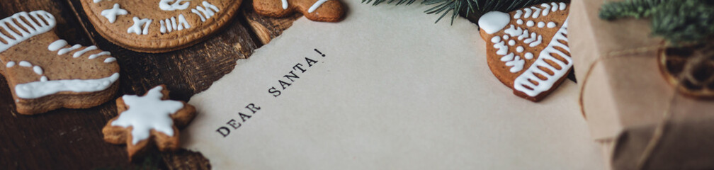 Banner. Christmas written letter with wish list with Dear Santa text. Xmas December tradition for kids and adults, cozy home decor, homemade gingerbread cookies, new year decoration, wooden background