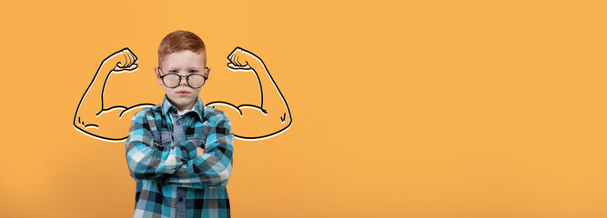 A young boy confidently poses with his arms crossed, demonstrating strength while surrounded by a...