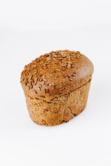 Whole grain bread loaf with sunflower seeds on white background, healthy bakery product