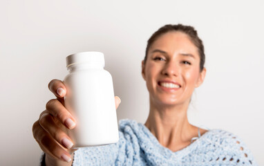 Woman holding a pill bottle. Pills bottle. Medical. Lifestyle. Flu. 