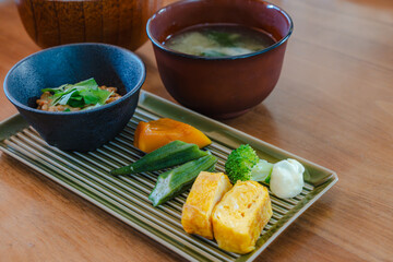 Japanese breakfast with natto, miso soup and side dishes
