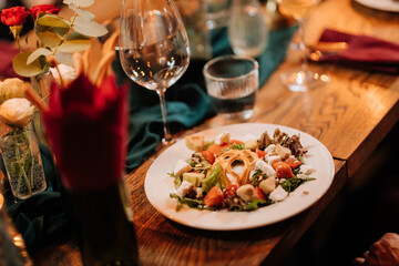 Fresh gourmet salad with goat cheese, croutons and watermelon at elegant dinner setting