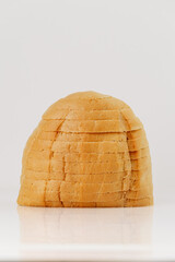 Freshly sliced white round loaf of bread isolated on white background, full frame