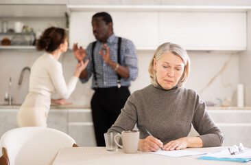Couple man and woman discussing testament with elderly woman in kitchen at home