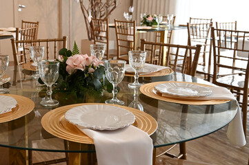 dining table with a beautiful and elegant setting, modern glass table set for a special occasion, stylish home interior for a dinner party, clean and simple table decor with soft lighting

