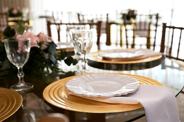 dining table with a beautiful and elegant setting, modern glass table set for a special occasion, stylish home interior for a dinner party, clean and simple table decor with soft lighting

