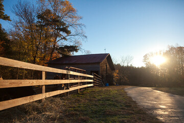 Fence and barn at golden hour