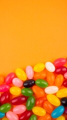 Obraz premium Colorful jelly beans on orange background