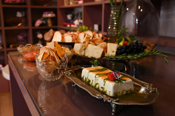 elegant buffet table with savory and sweet foods, delicious appetizers for a special event, gourmet catering with assorted breads and cheese, beautiful and abundant party food display

