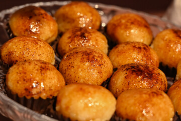 gourmet artisanal sweets with a caramelized topping, traditional brazilian treats on a serving plate, delicious brigadeiros or bem-casados for a party, golden-brown confections for a celebration

