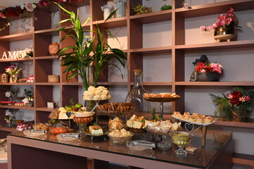 
buffet with a variety of artisanal sweets and pastries, elegant table of delicious party snacks, beautiful and abundant celebration food display, homemade treats and appetizers on a buffet table


