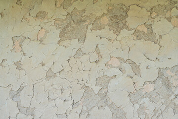 Close-up view of peeling, rough, uneven, textured paint in an ancient Central European village muted earthy tones no human presence or distinguishable objects natural lighting slightly angled per