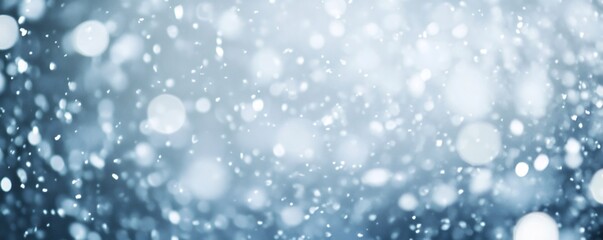 Obraz premium Christmas snow is gently falling against a blurred, sparkling background, evoking a festive and magical atmosphere