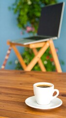 Laptop and coffee on a wooden table