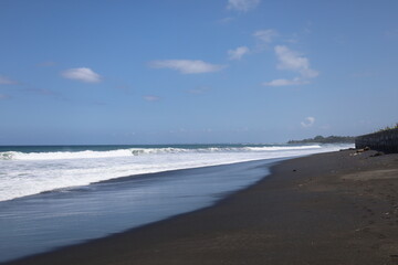 black sand beach and sea