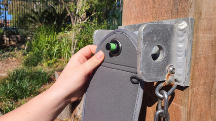 Student unlocking a YONDR lockable mobile phone case pouch