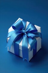 Obraz premium Gift box on a dark blue background with a large ribbon bow made of blue satin and white tissue paper wrapped around it, decorative box, packaging, wrapping paper