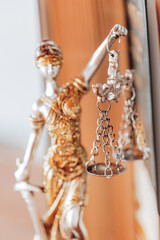 Statue of Themis on the books background.Scales of Justice Statue.Justice Statue with Law Books. Books on jurisprudence.