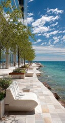 Seaside promenade with modern benches, lush greenery, and a modern building backdrop