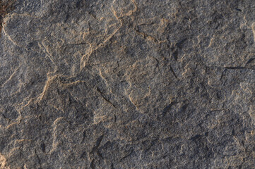 Sunlit Stone Surface Texture with Natural Patterns