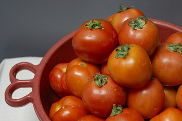 A still life of healthy red tomatoes, a key ingredient for cooking.