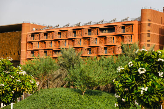 The Masdar Institute of Science and Technology exterior with green garden on the foreground. Sustainable environment.