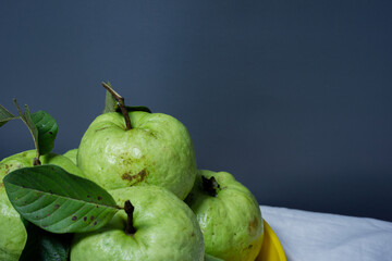 Close-up of fresh guava fruit on a gray background