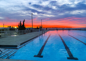 Sunrise View Over Swimming Pool With Vibrant Colors and Clear Sky in Babylon