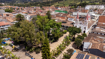 Fototapeta premium La Ceja del Tambo, Antioquia, Colombia. June 21, 2025. Panoramic drone view of the town's main church