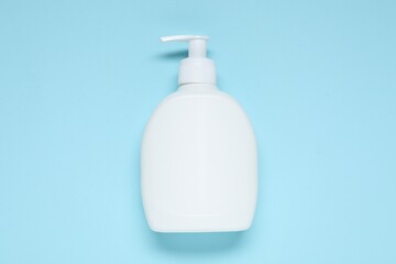 Cosmetic product on light blue background, top view. Mockup for design