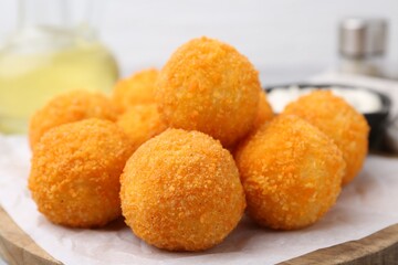 Delicious fried croquette balls on table, closeup