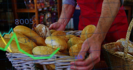 Arranging baker wearing red apron placing assorted bread in woven baskets on counter in bakery