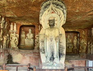 Big standing Buddha statue in Dayun Ancient Grotto at Thousand-Buddha Cliff on bank of Jialing River in Guangyuan, Sichuan, China, constructed from late Northern Wei Dynasty.