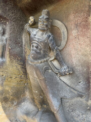 Statue of vivid guardian warrior at entrance to a grotto at Thousand-Buddha Cliff along bank of Jialing River in Guangyuan, Sichuan, China, constructed from late Northern Wei Dynasty.