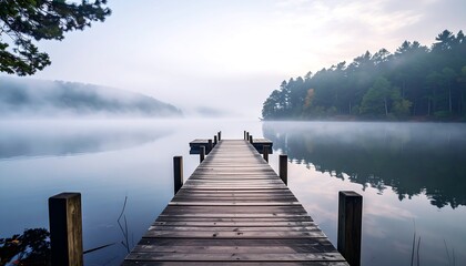 Misty lake dock in tranquil morning light