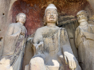 Statues of Buddha and two Disciples in Northern Big Buddha Grotto at Thousand-Buddha Cliff along bank of Jialing River in Guangyuan, Sichuan, China, constructed from late Northern Wei Dynasty.