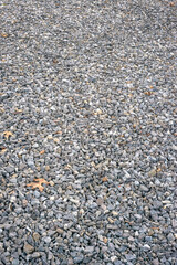 Natural gray gravel texture with scattered small stones background