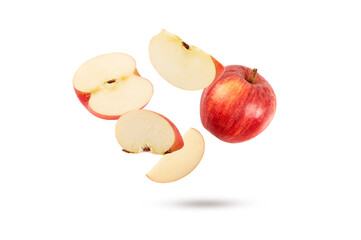 falling red apple with half and slice isolated on white background.