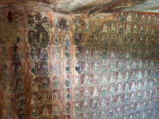 Thousand small Buddha relief on rock walls in Thousand-Buddha Grotto at Thousand-Buddha Cliff in Guangyuan, Sichuan, China, constructed from late Northern Wei Dynasty.