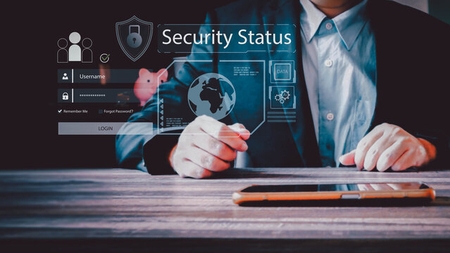 A businessman interacts with a futuristic holographic security interface. The virtual screen shows a login, a globe, and data for cybersecurity analysis at a desk.