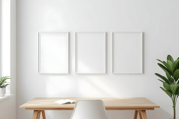 Fototapeta premium Bright workspace featuring three blank white frames above a minimalist desk setup and plant