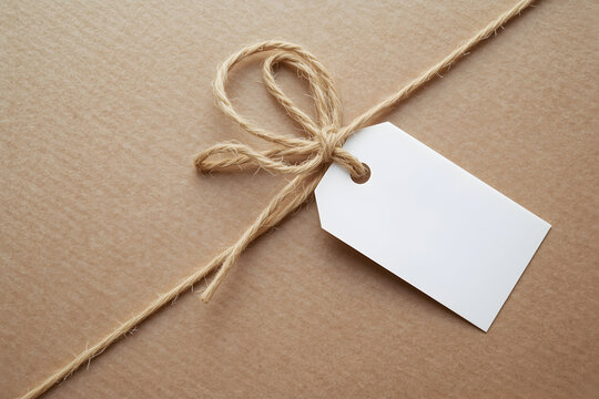 Close-up image featuring a neatly wrapped parcel adorned with natural twine and a blank tag