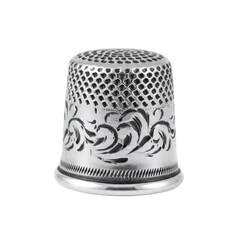 Close Up of Ornate Silver Thimble with Intricate Floral Pattern Against Black Background Sewing Accessory Finger Protection