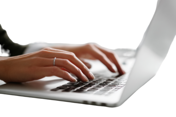Hands typing on a laptop
