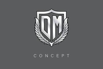 DM Creative Initial Letter Logo with Shield and Laurel Wreath Silver Metallic Branding Emblem on Gray Background.