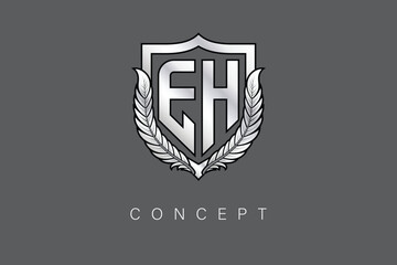 Obraz premium EH Creative Initial Letter Logo with Shield and Laurel Wreath Silver Metallic Branding Emblem on Gray Background.